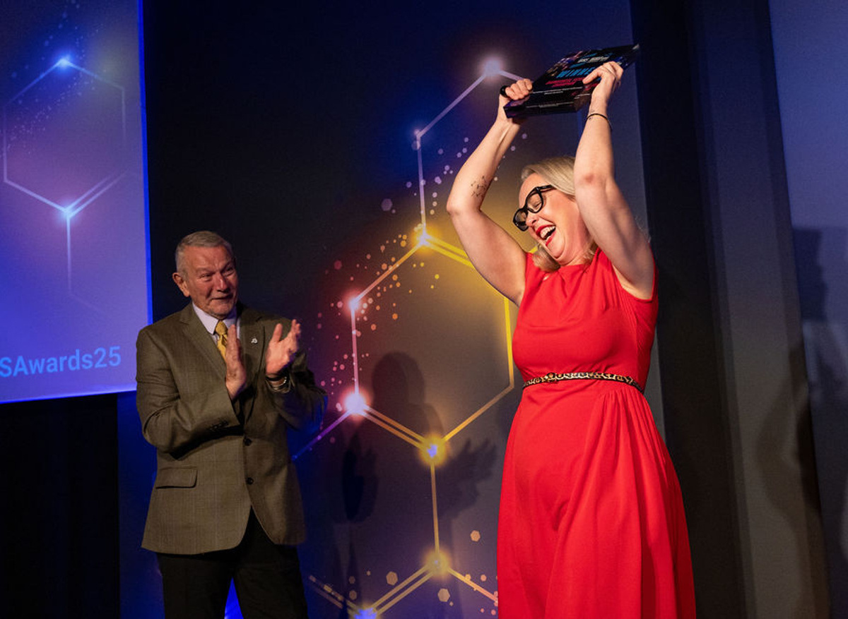 Gayle celebrating her win with Harvey's Lab Tours Founder, Malcolm Robinson
