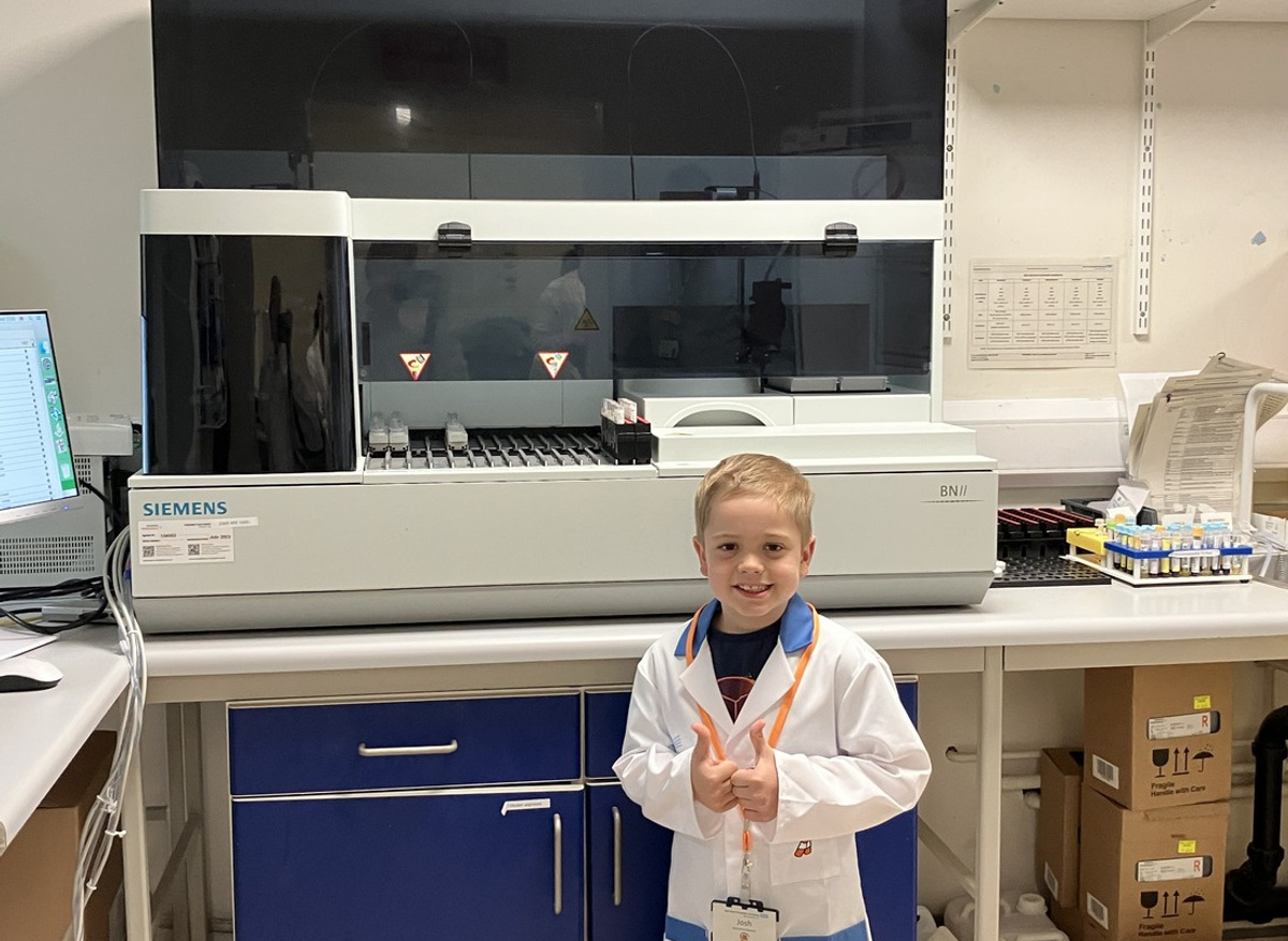 Josh with the immunology analyser that measures IgG in blood samples