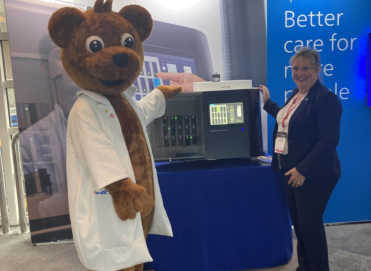 Harvey Bear testing out lab equipment with Phillips