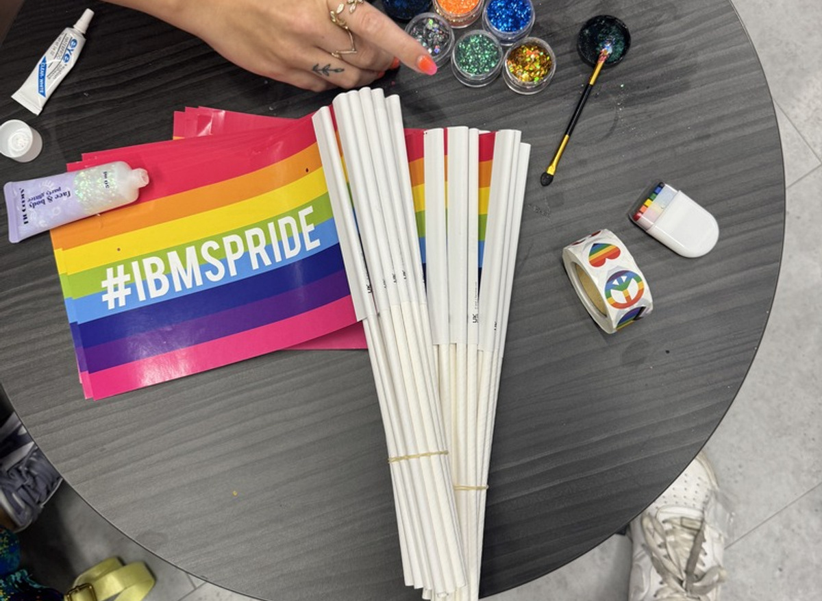 Flags, glitter and Pride stickers laid out and ready to go.