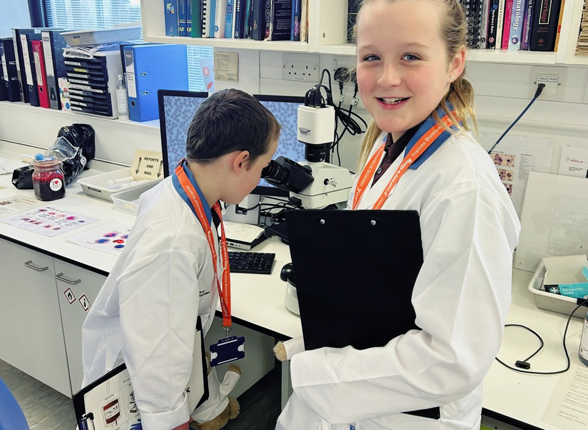 Andrew and Hannah looking down the microscope