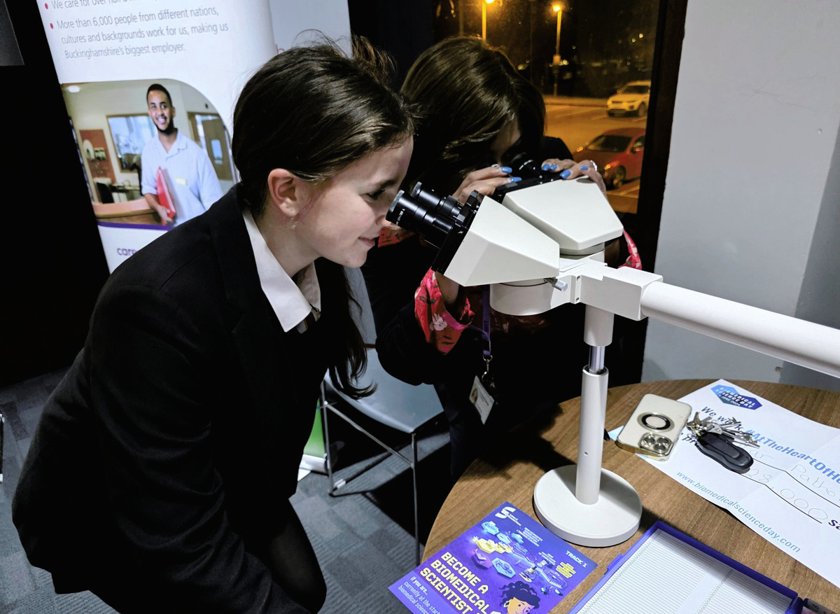 Students using laboratory microscopes